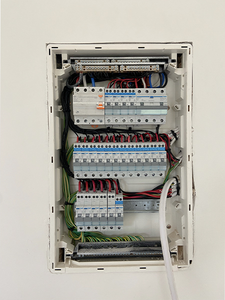 Certified electrician installing modern switchboard with safety features